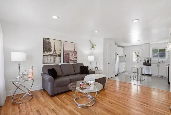 Living room with light wood-style floors and recessed lighting