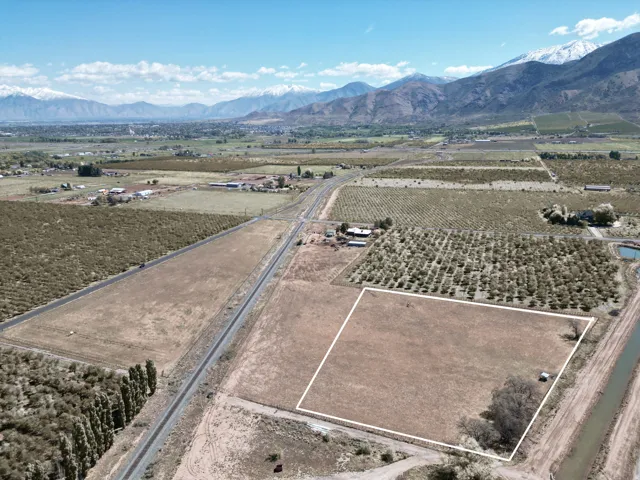 Aerial view of property's location featuring rural landscape, rows of crops, and property boundaries highlighted