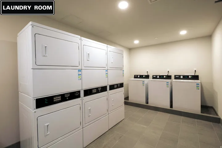 Shared laundry room with recessed lighting and stacked washer / drying machine