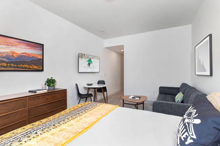 Bedroom with wood finished floors and baseboards