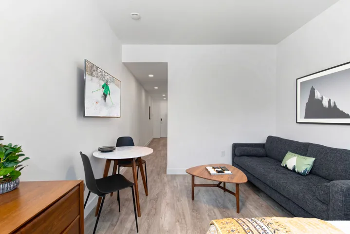 Living room featuring light wood-style floors and baseboards