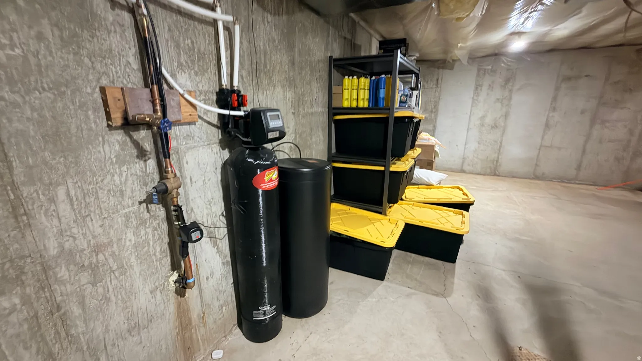 Unfinished below grade area with a water softener system