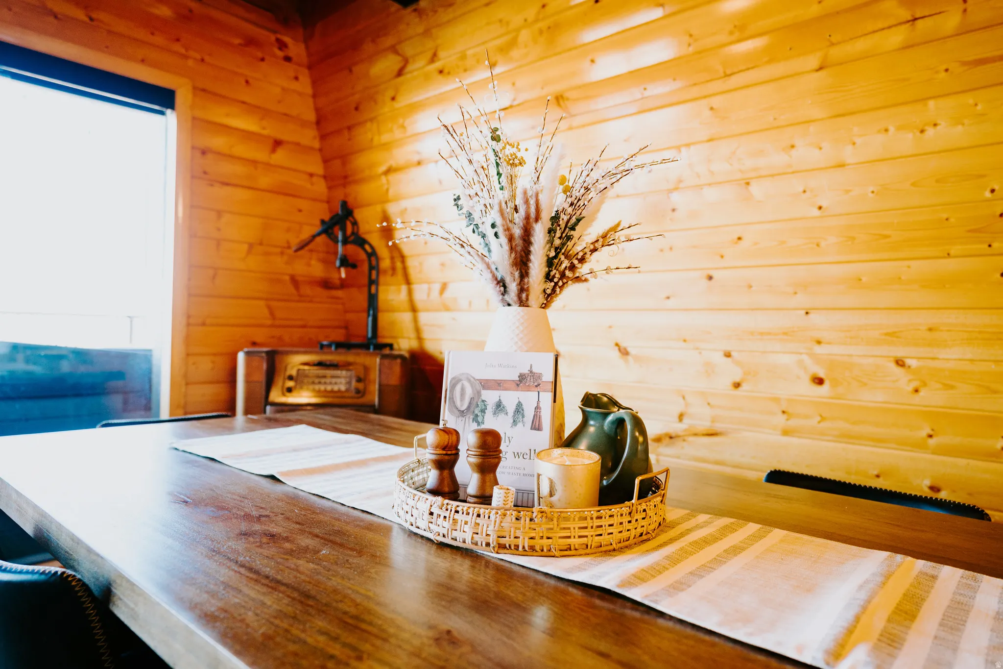 Dining area featuring wooden walls and plenty of natural light