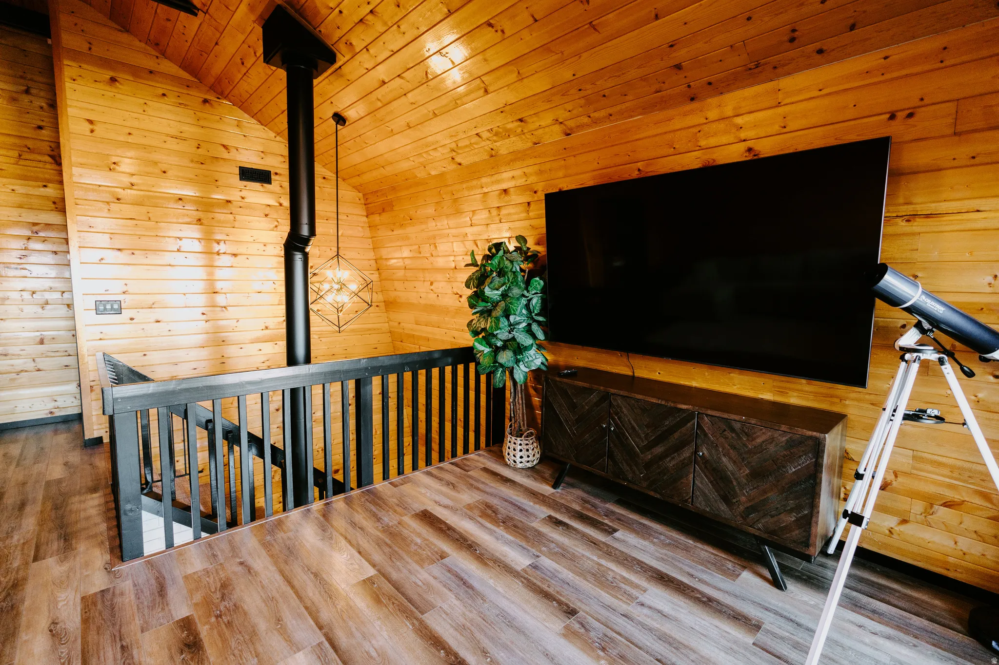 Staircase featuring wood walls, wood ceiling, and wood finished floors