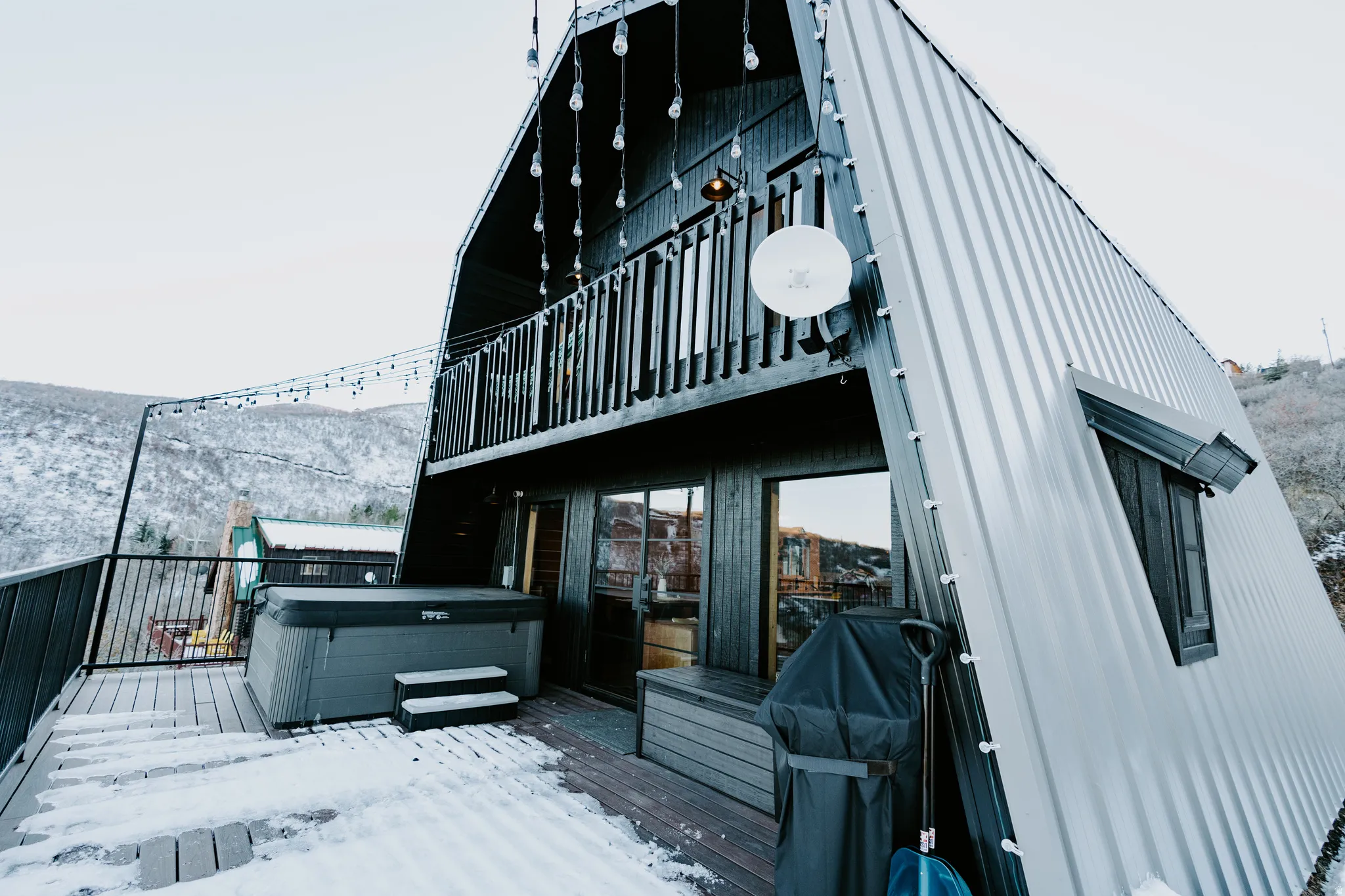 Deck with a hot tub and grilling area