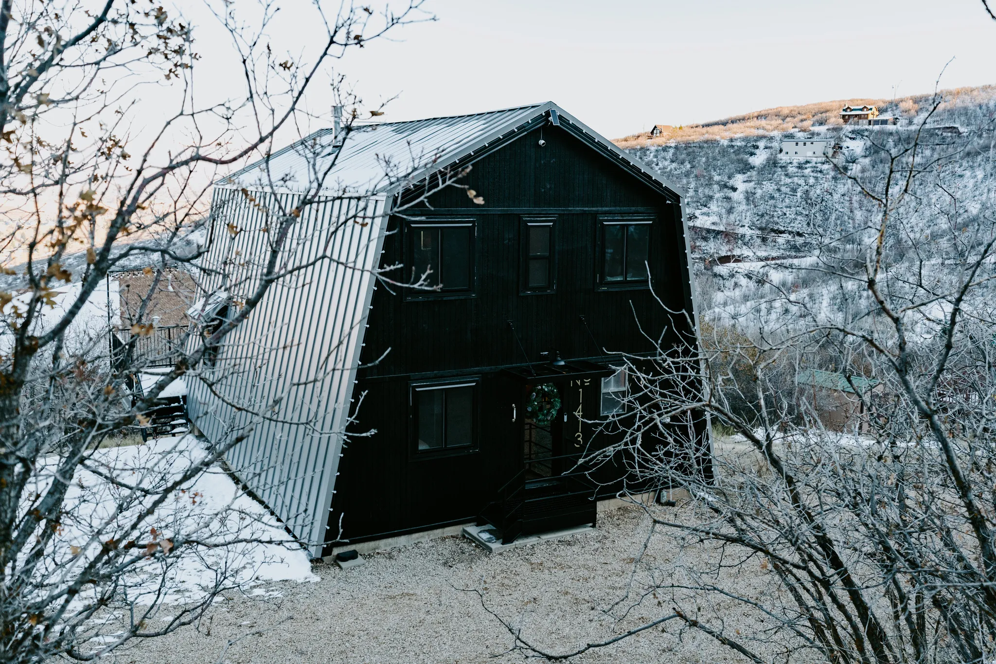 Rear view of house featuring a gambrel roof