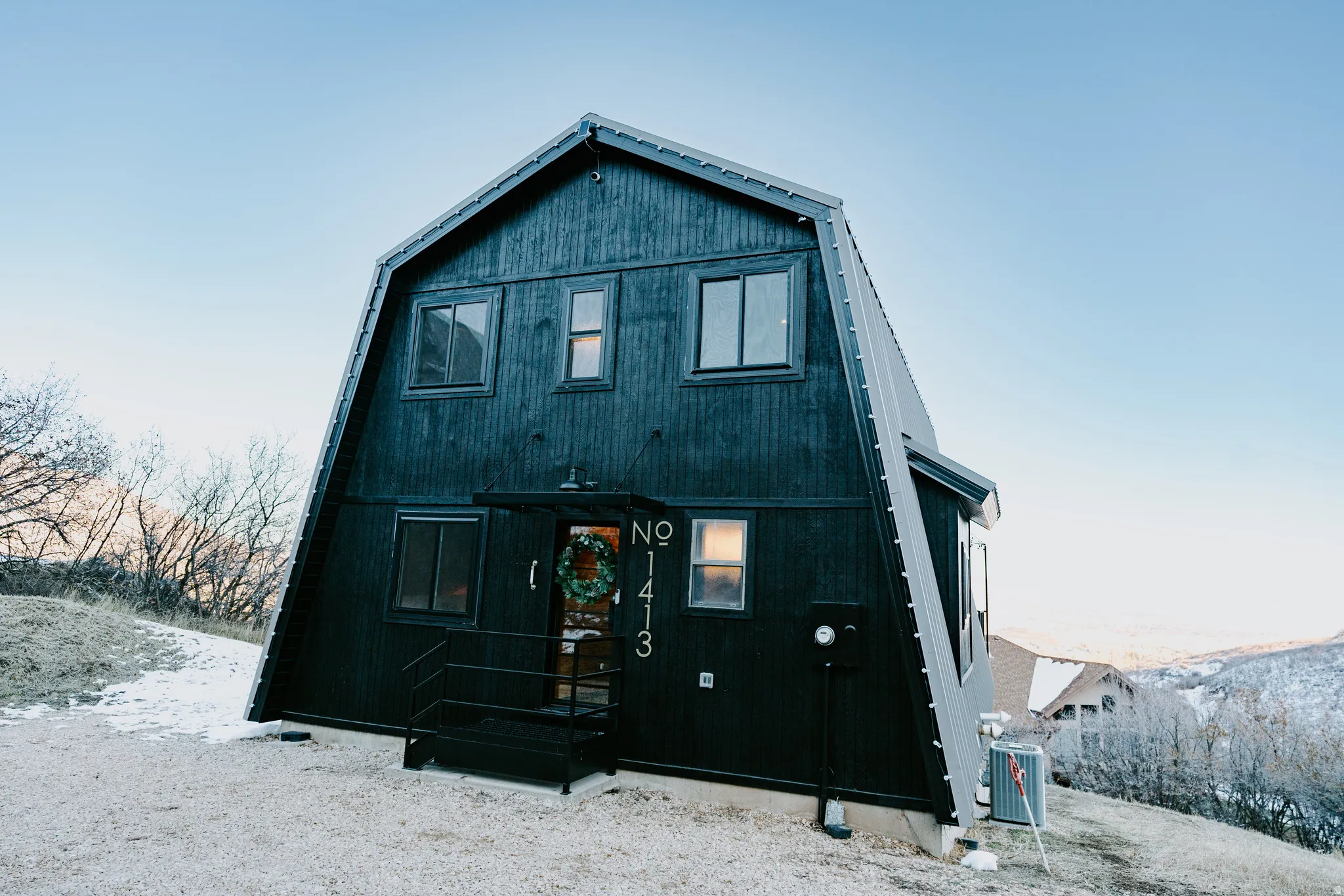 Back of property featuring a gambrel roof