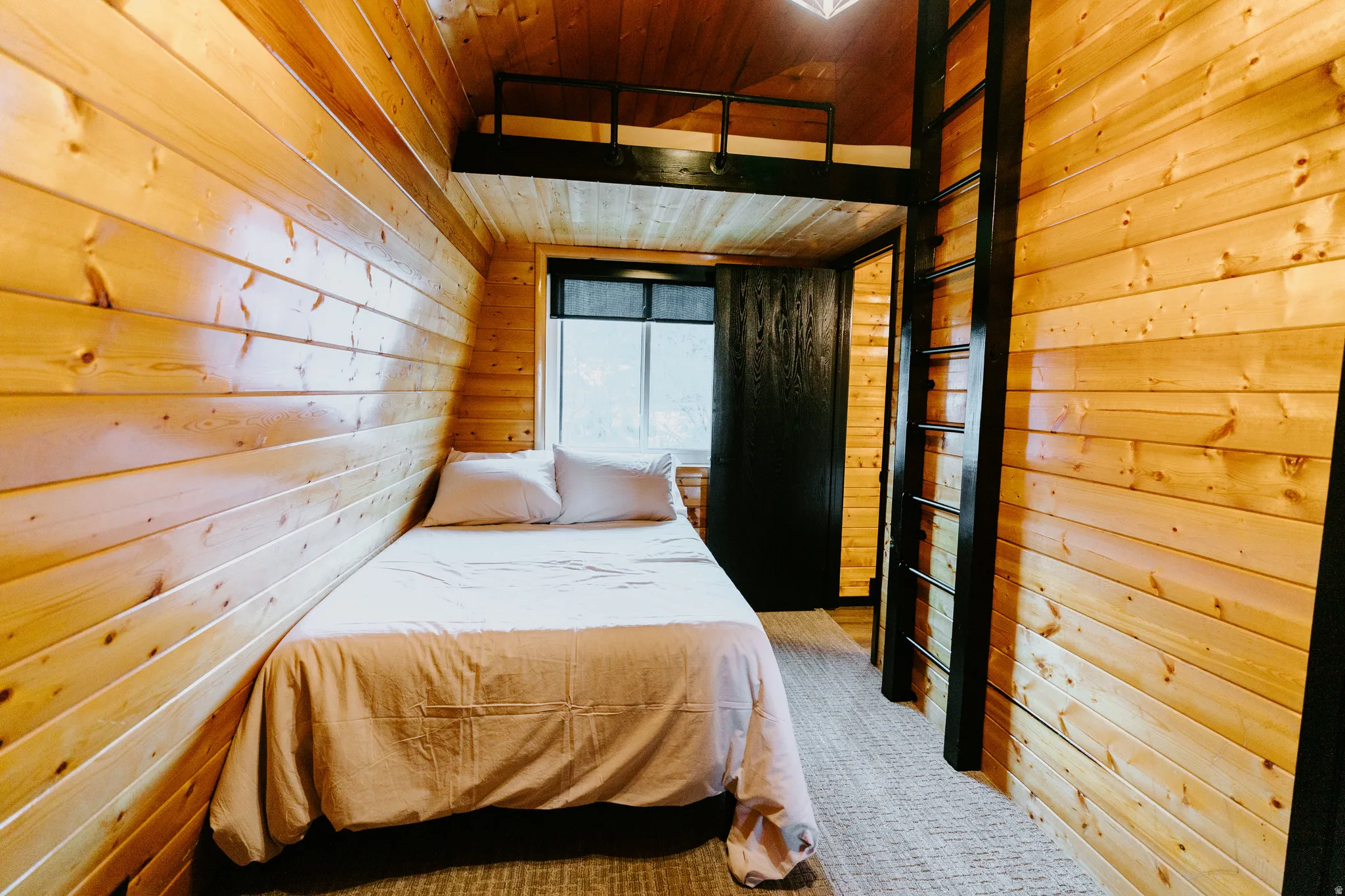 Bedroom with wood ceiling and wooden walls