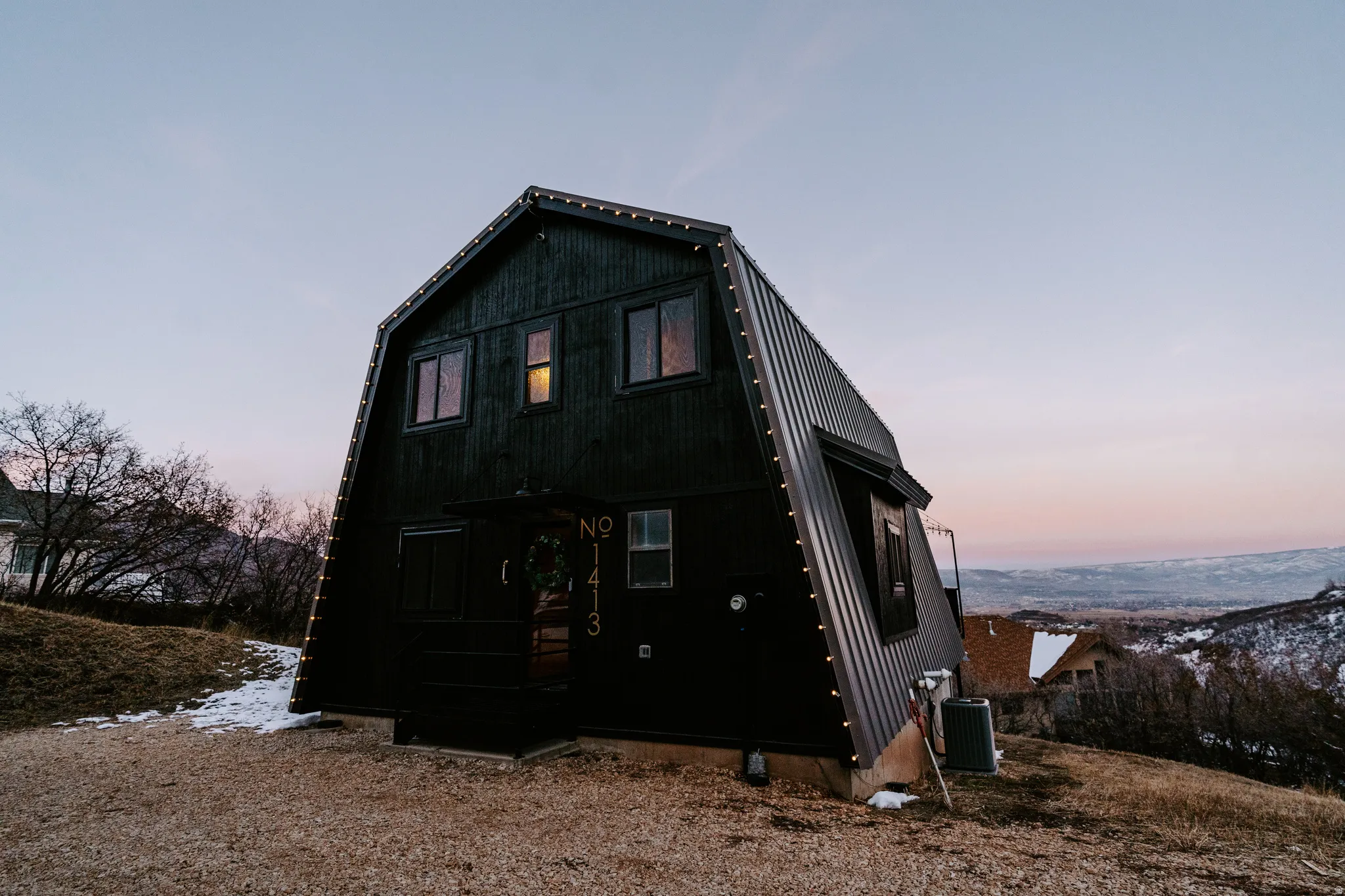 Rear view of property with a gambrel roof