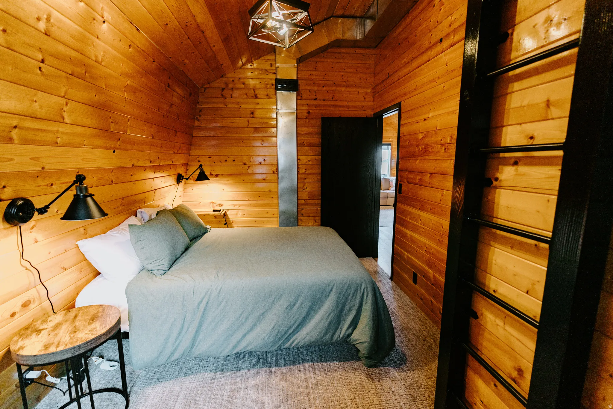 Bedroom featuring wood walls and lofted ceiling