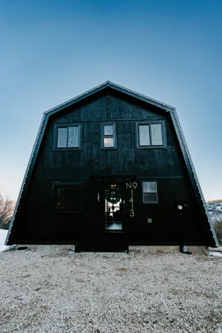 Rear view of property featuring a gambrel roof
