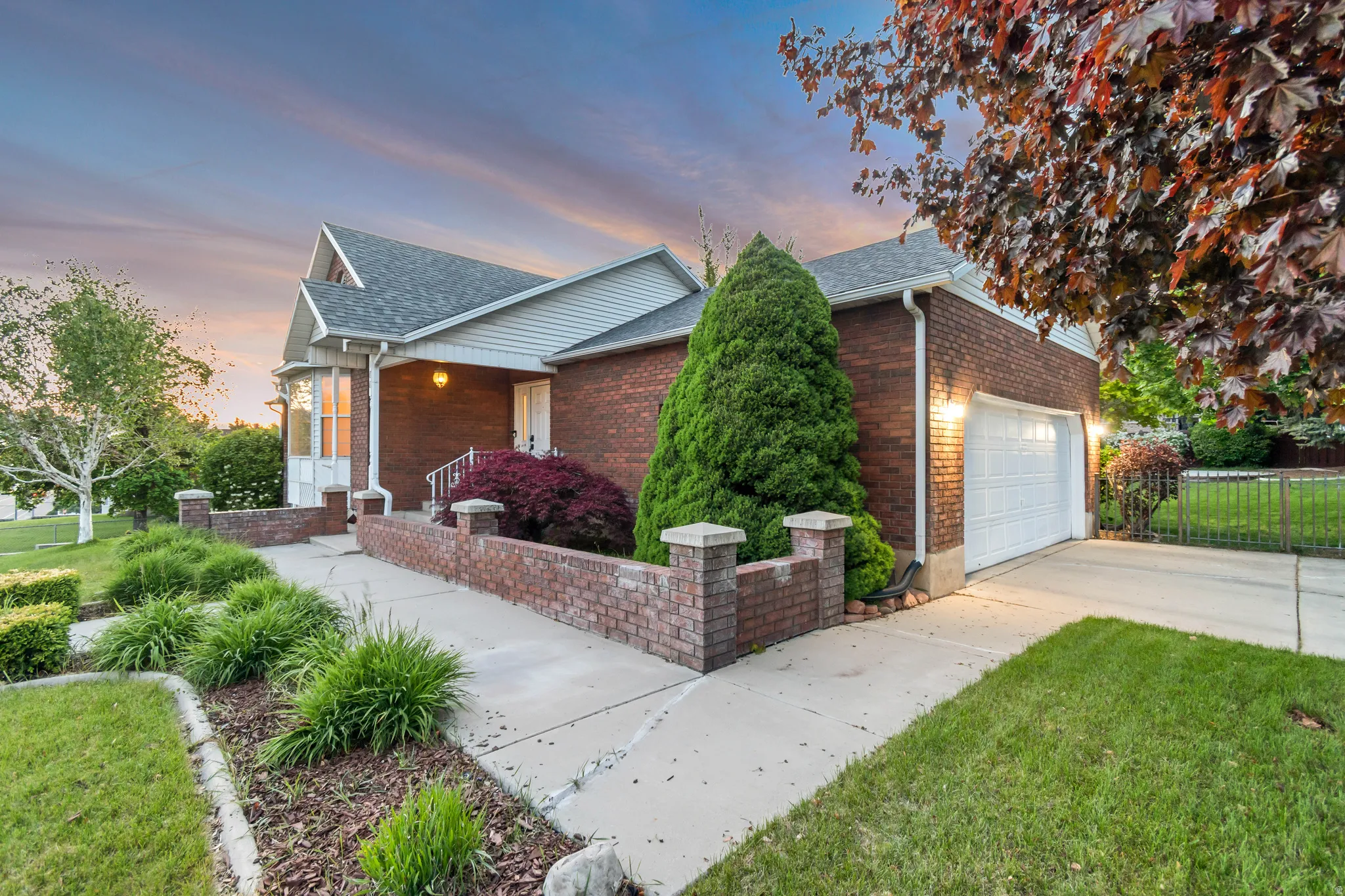 Brick exterior with white siding accents and a contrasting gray shingle roof