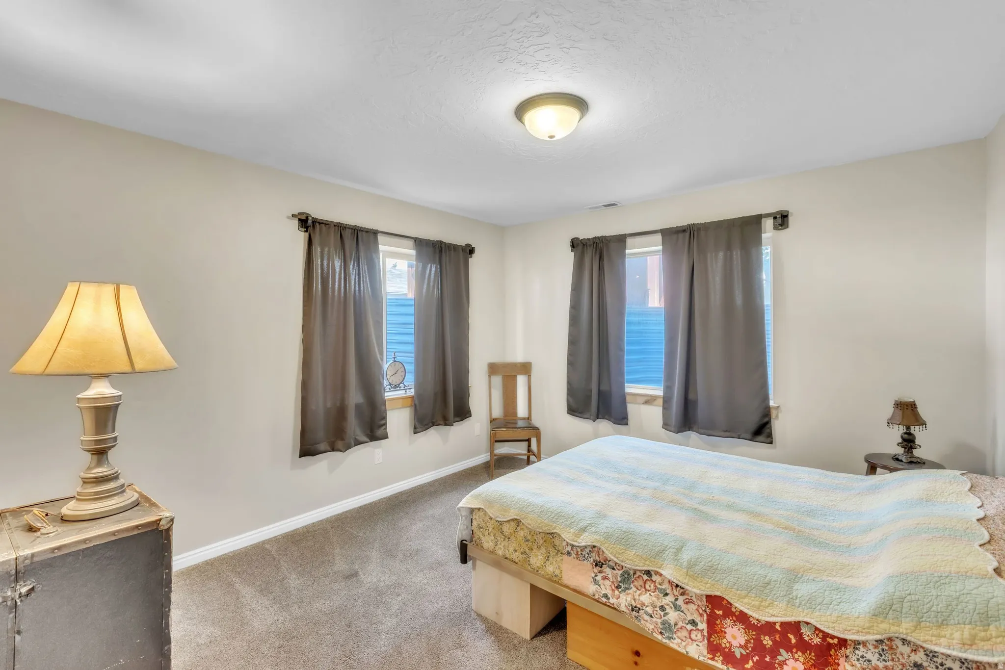 Bedroom with light carpet and baseboards