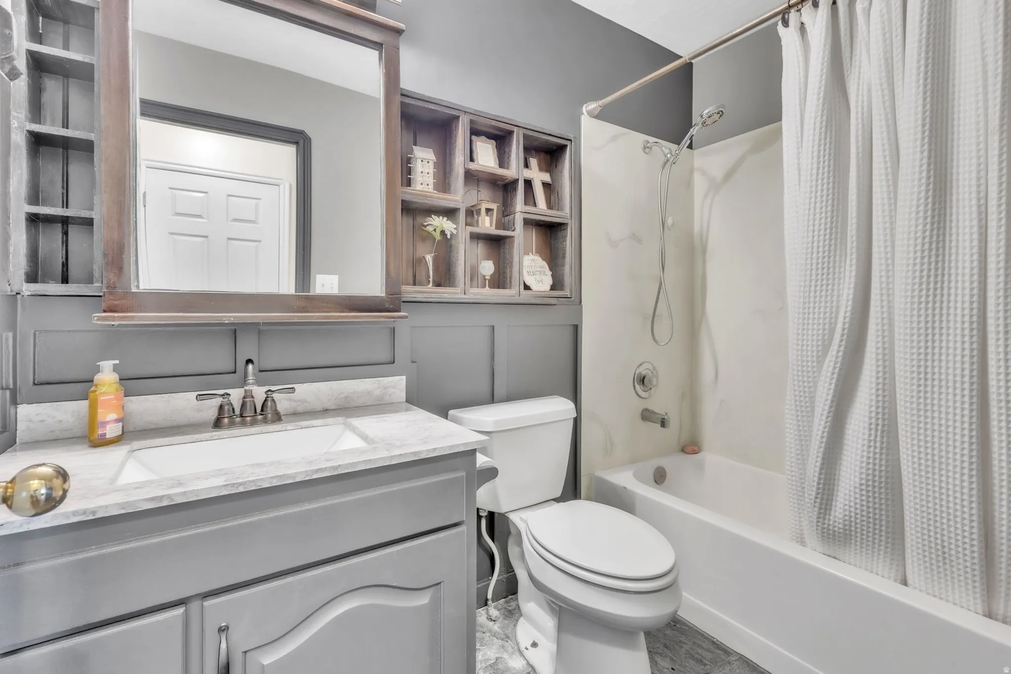 Full bath featuring vanity and shower / bath combination with curtain