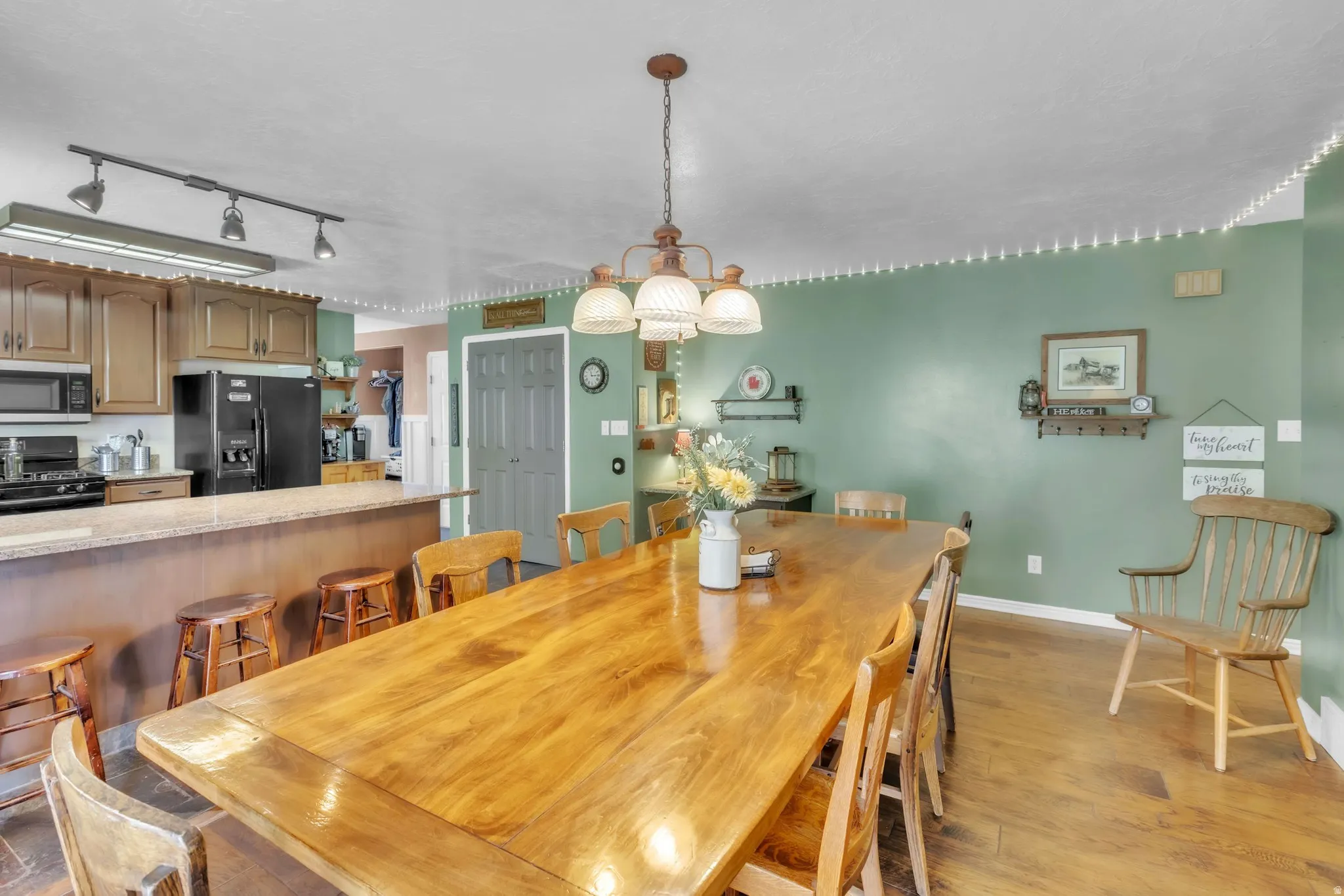 Dining area with light wood-style floors and a chandelier