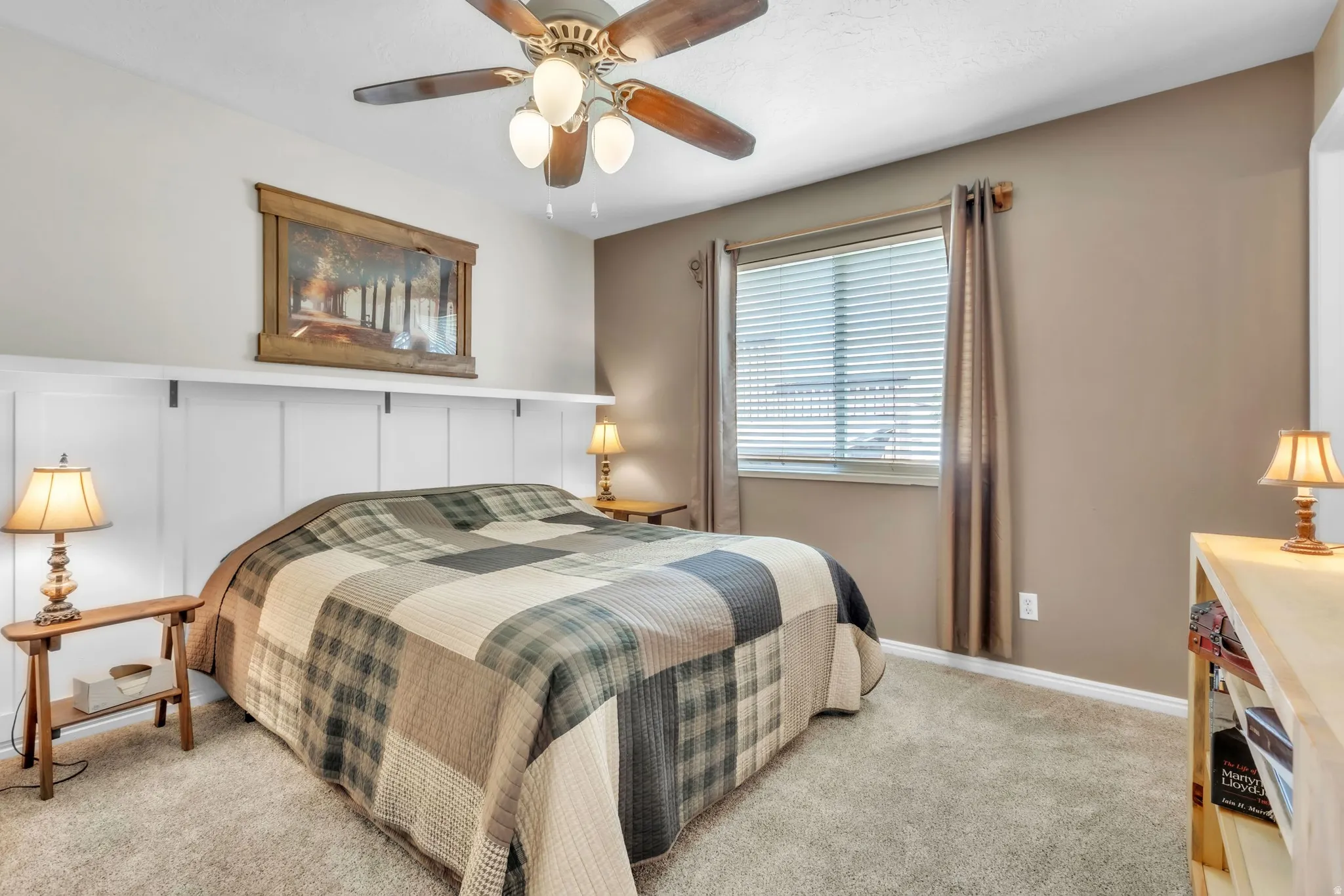 Bedroom featuring light colored carpet and a ceiling fan