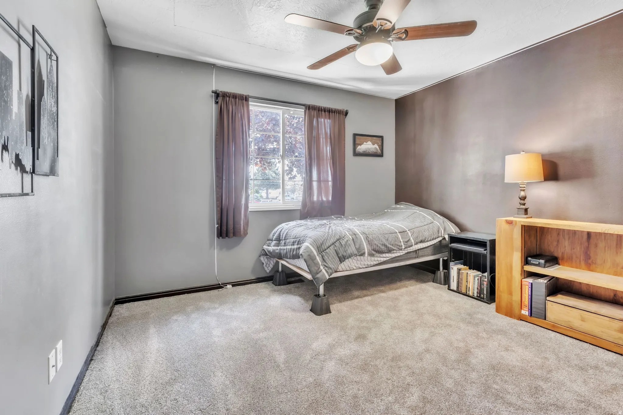 Bedroom with a ceiling fan and carpet floors