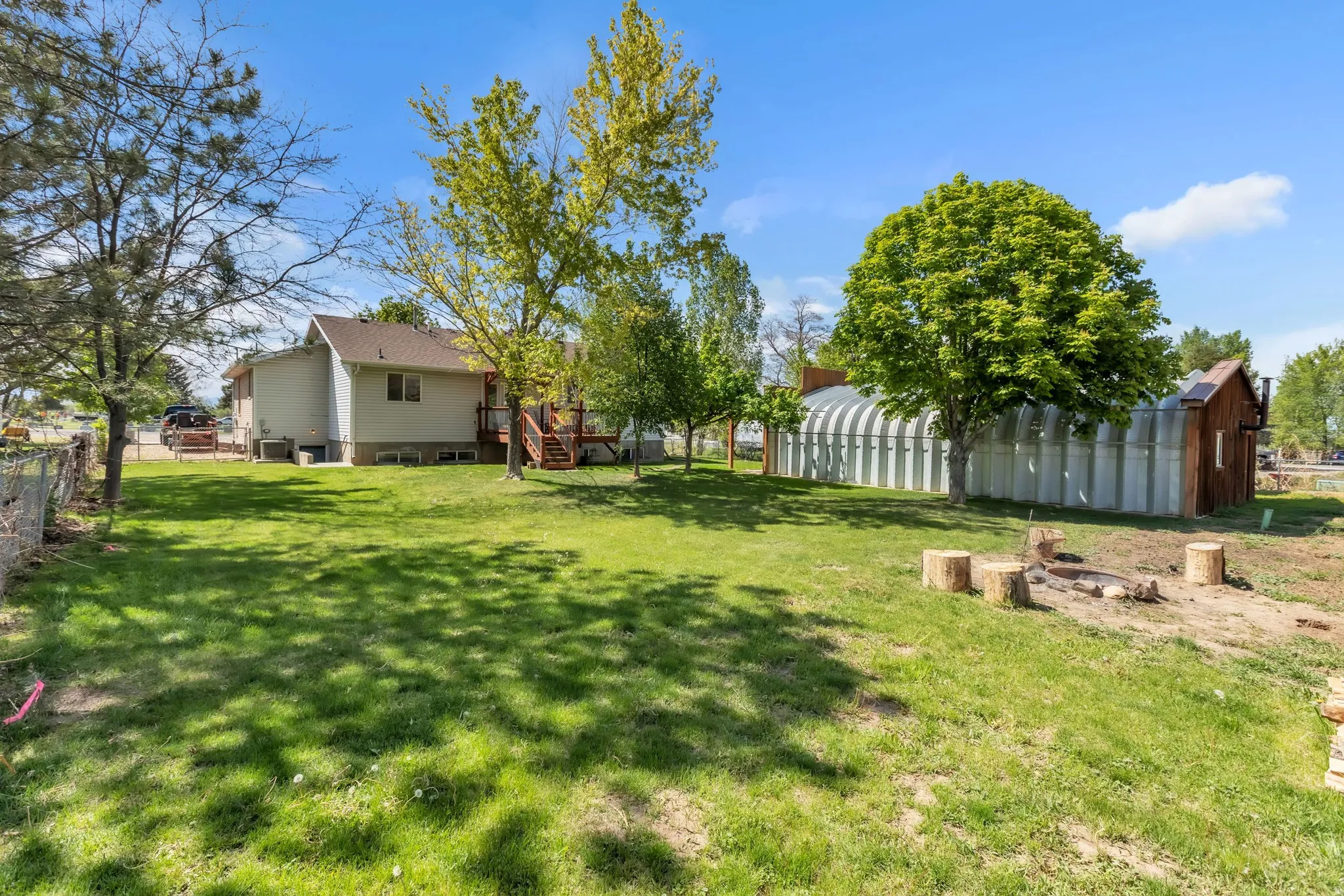 View of yard with a wooden deck and an outbuilding