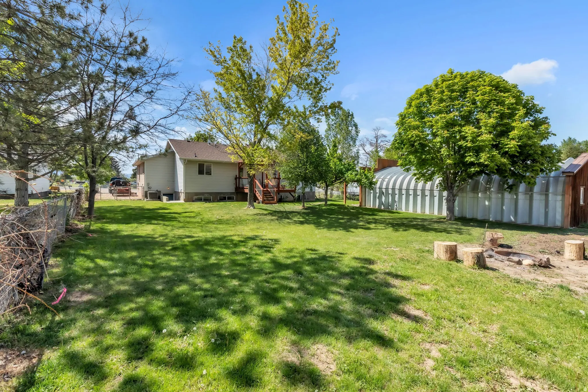 View of yard featuring a deck and an outbuilding