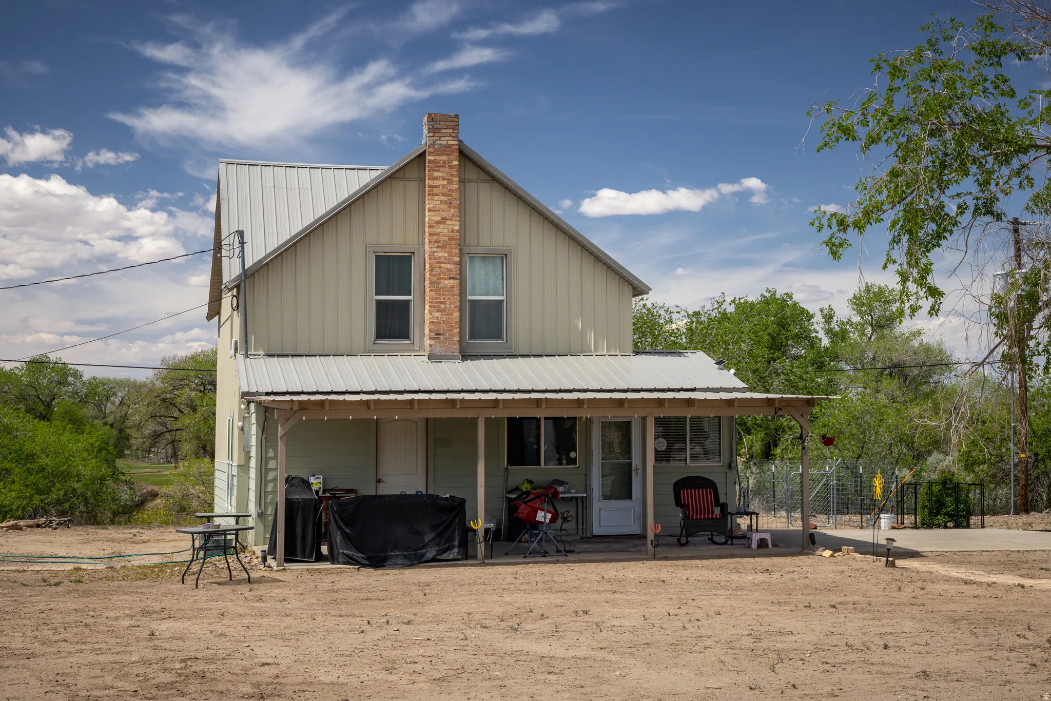View of front of home with a metal roof and board and batten siding