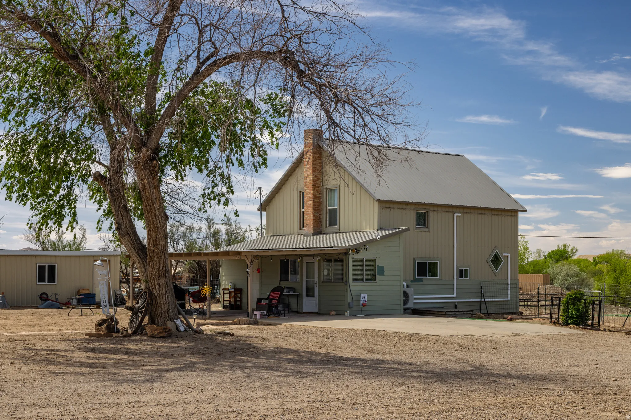 Back of property featuring a metal roof and a chimney