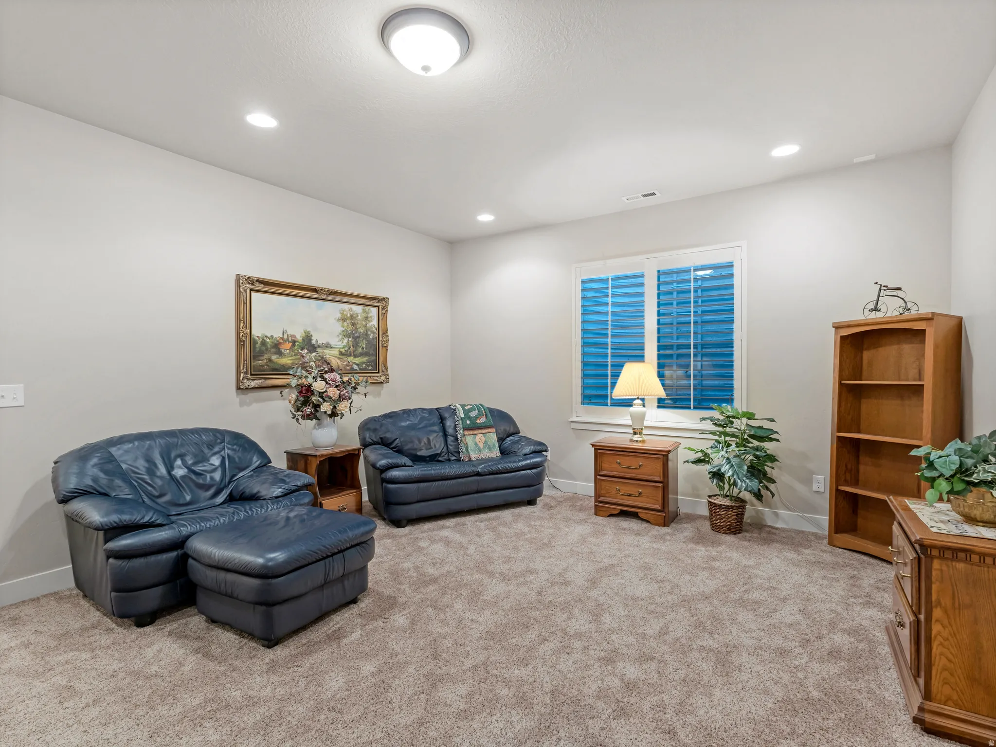 Sitting room with carpet flooring and recessed lighting