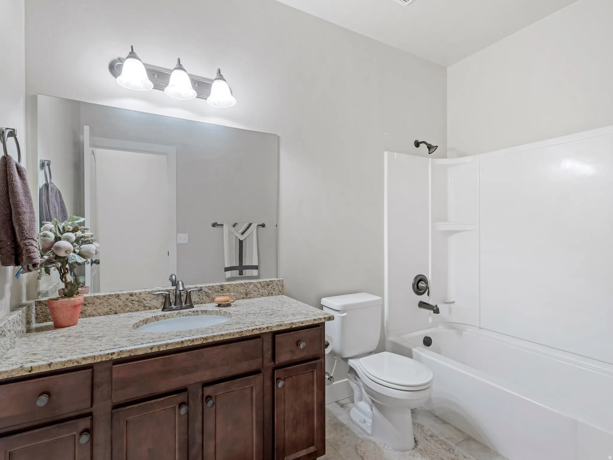 Full bath featuring vanity and shower / bath combination