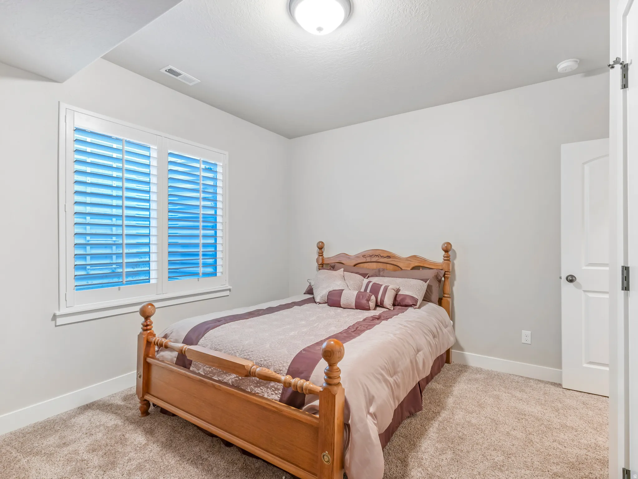 Bedroom with baseboards and carpet