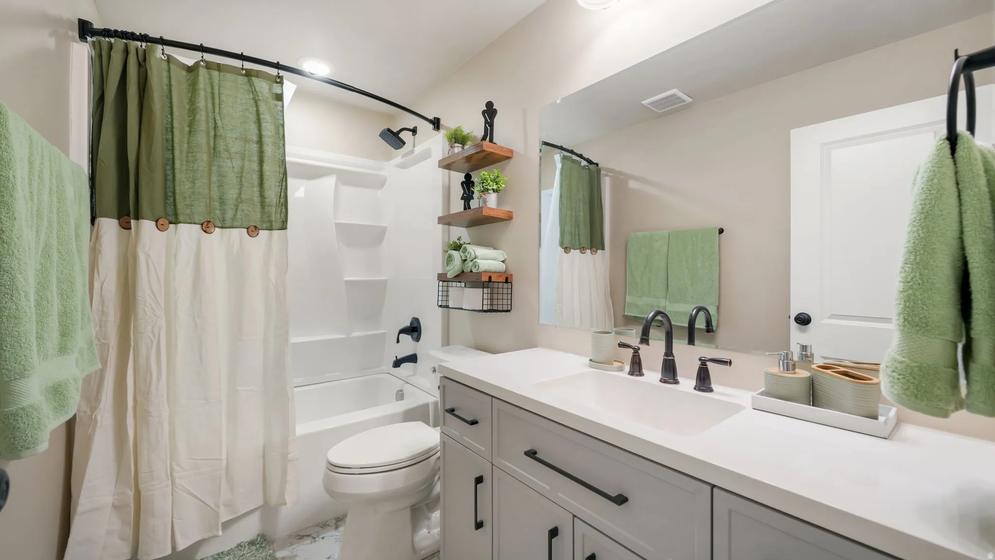 Full bath with vanity and shower / bath combo