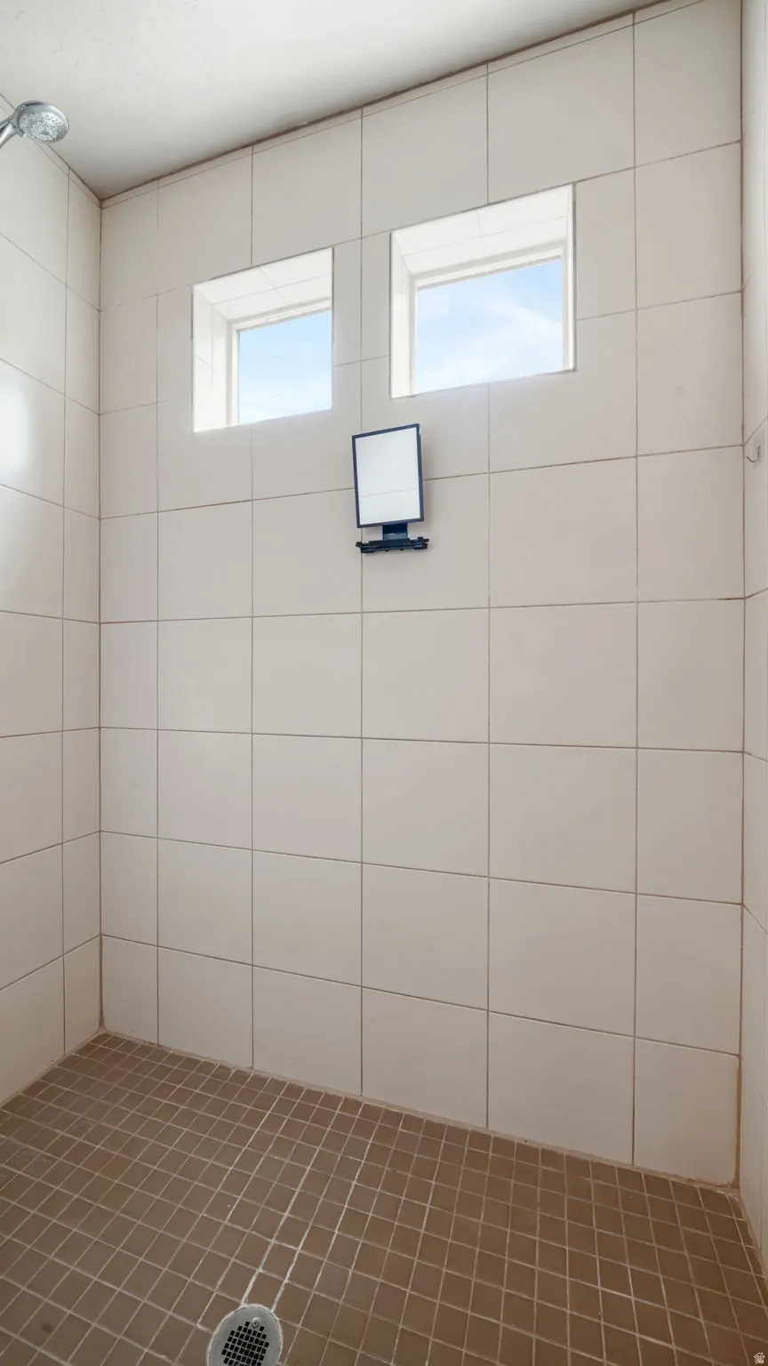 Master bathroom featuring walk in tiled shower