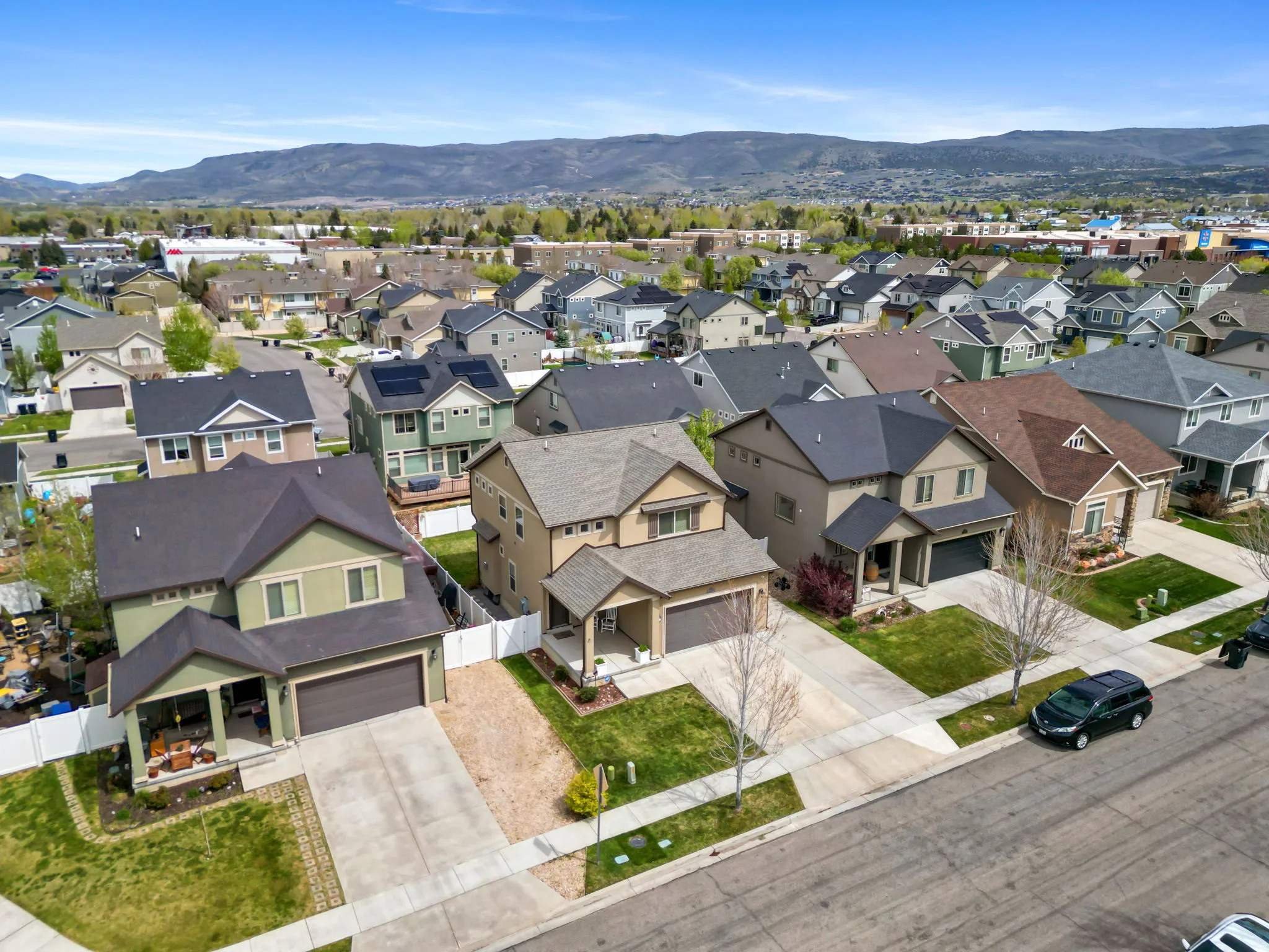 Aerial view of residential area featuring a mountainous background