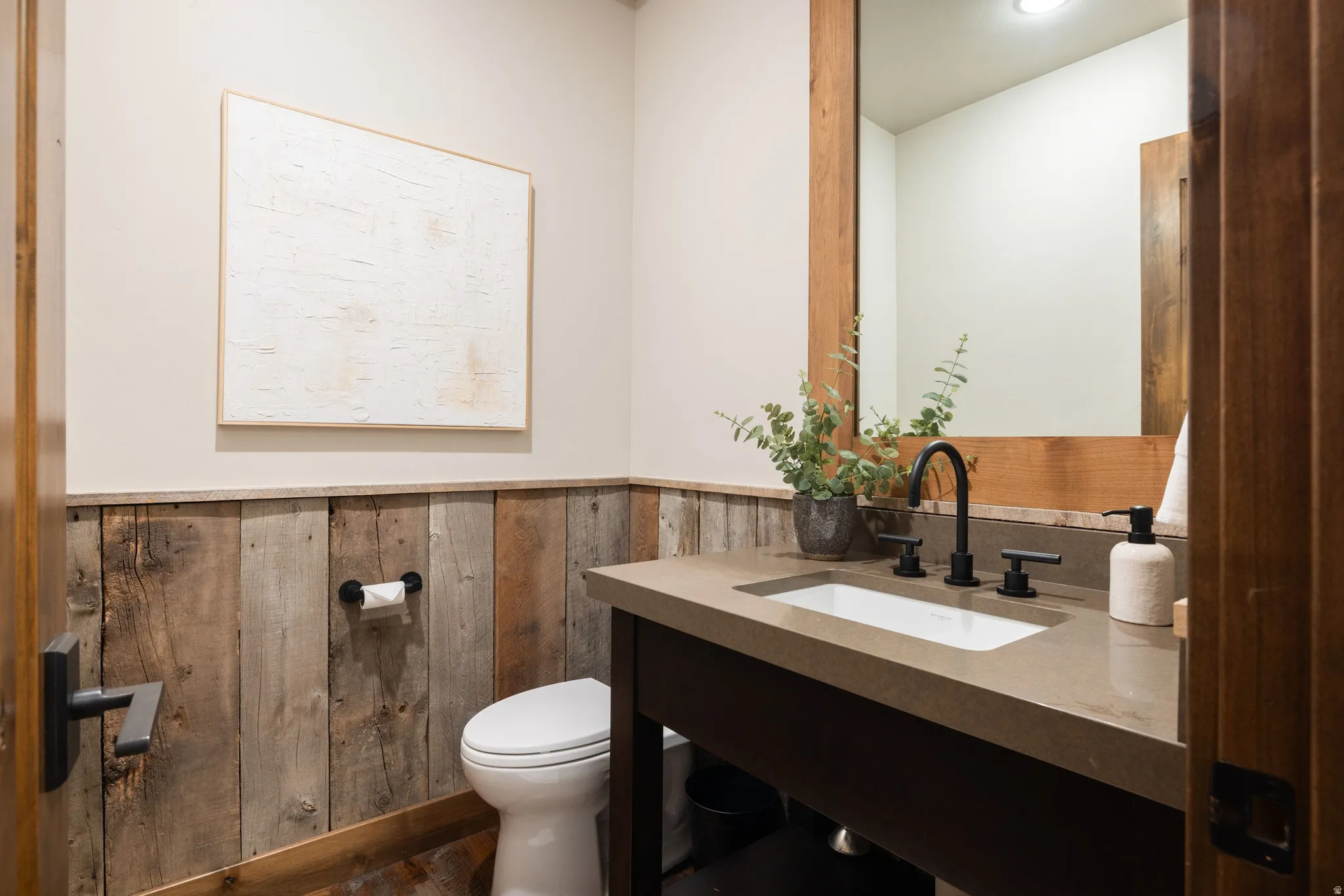 Bathroom with vanity and wainscoting