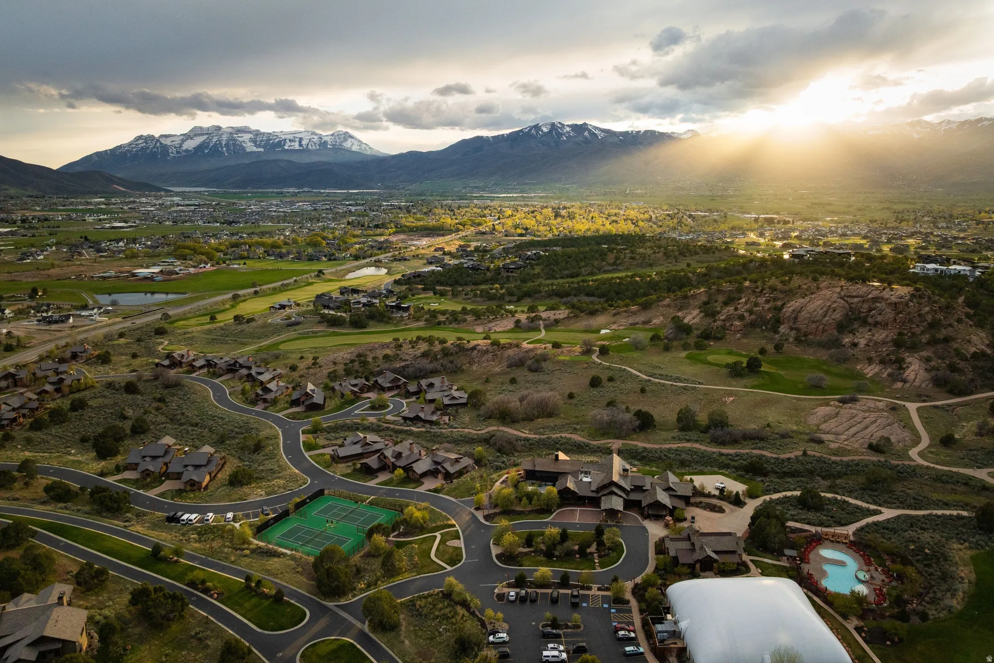 Aerial perspective of suburban area featuring a water and mountain view and a local golf course