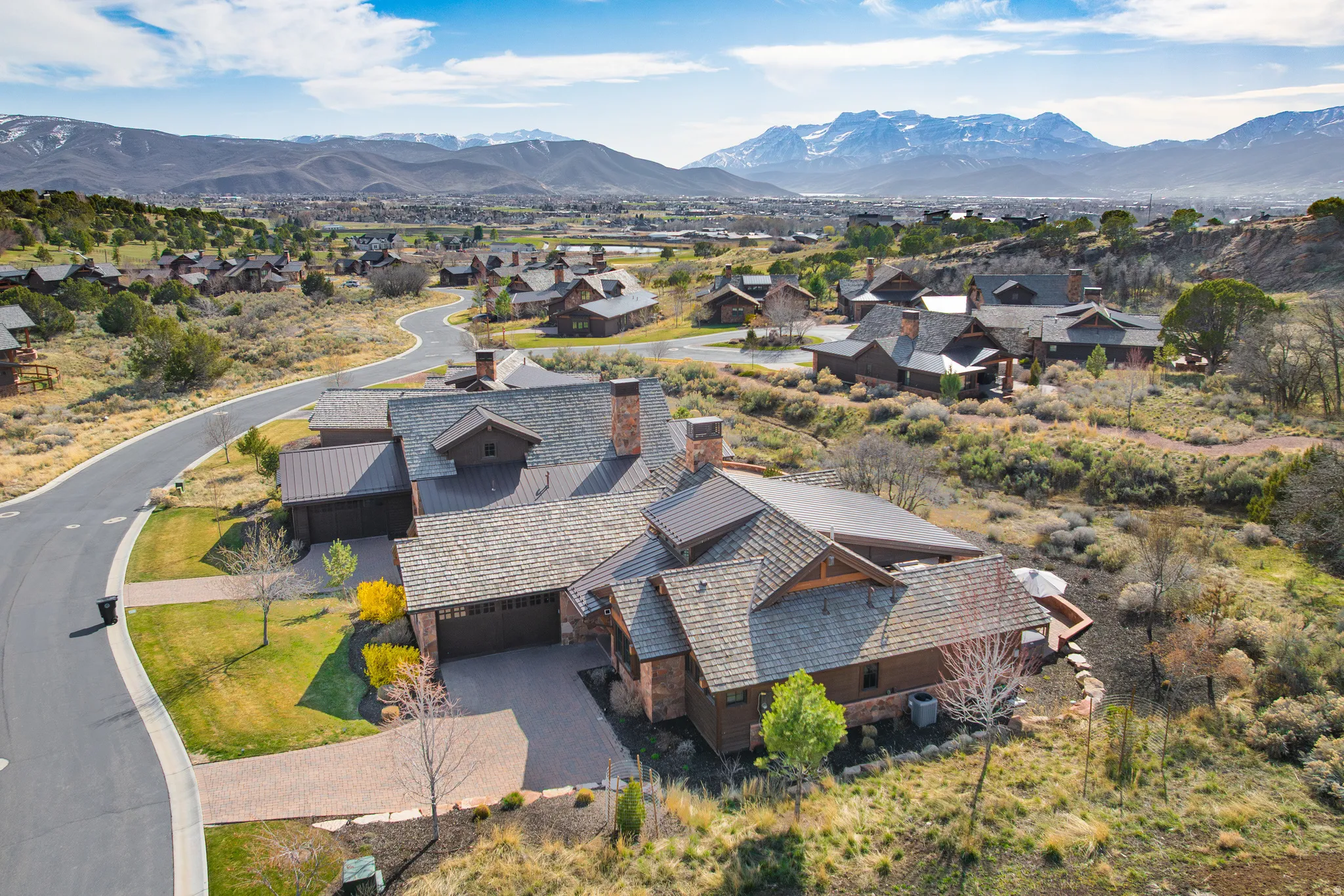 Aerial perspective of suburban area with a mountainous background