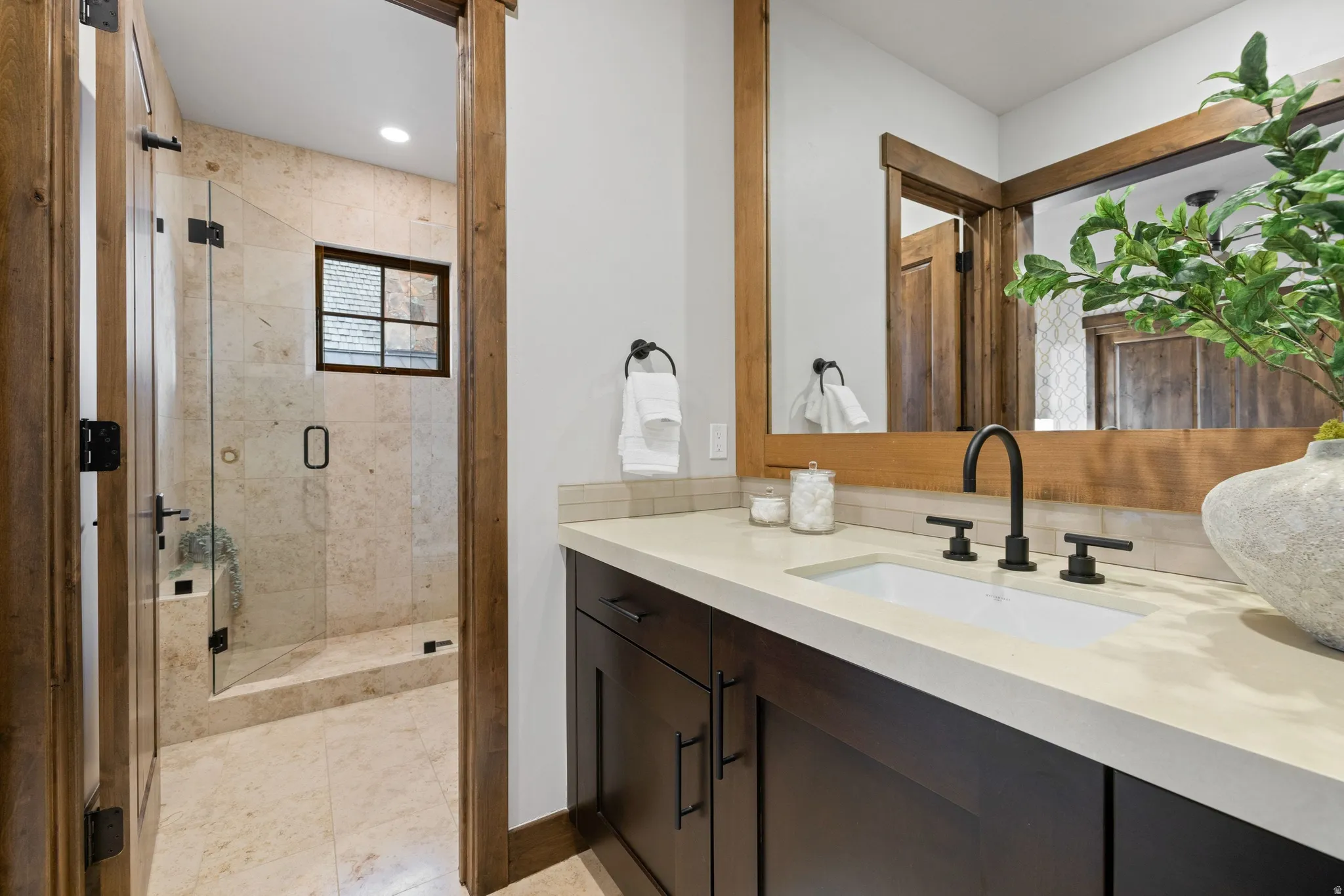 Bathroom with vanity, a stall shower, and recessed lighting