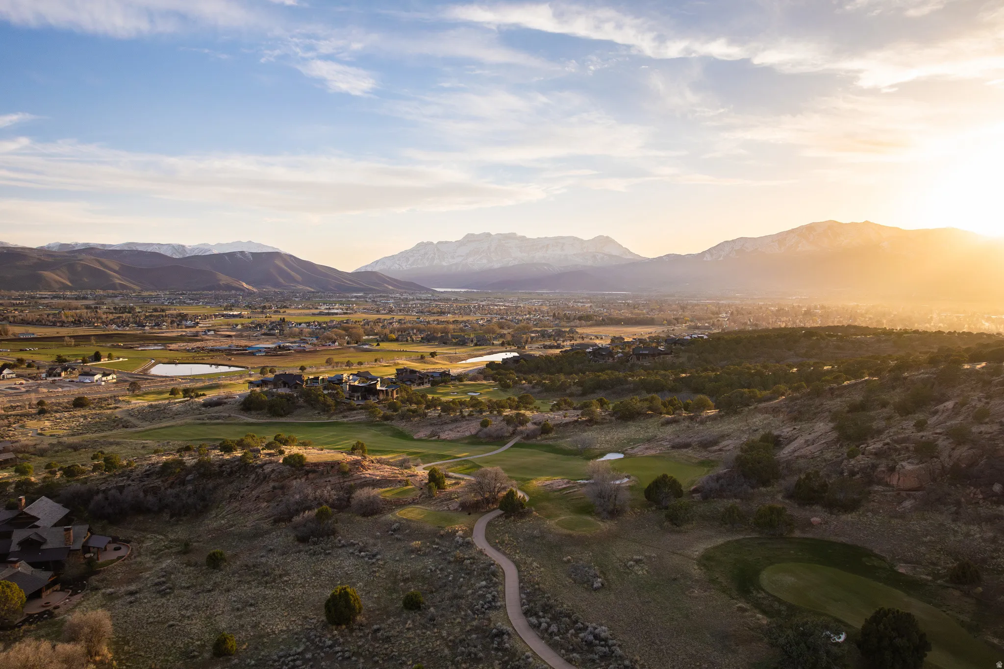 View of mountain background featuring a golf club and a nearby body of water