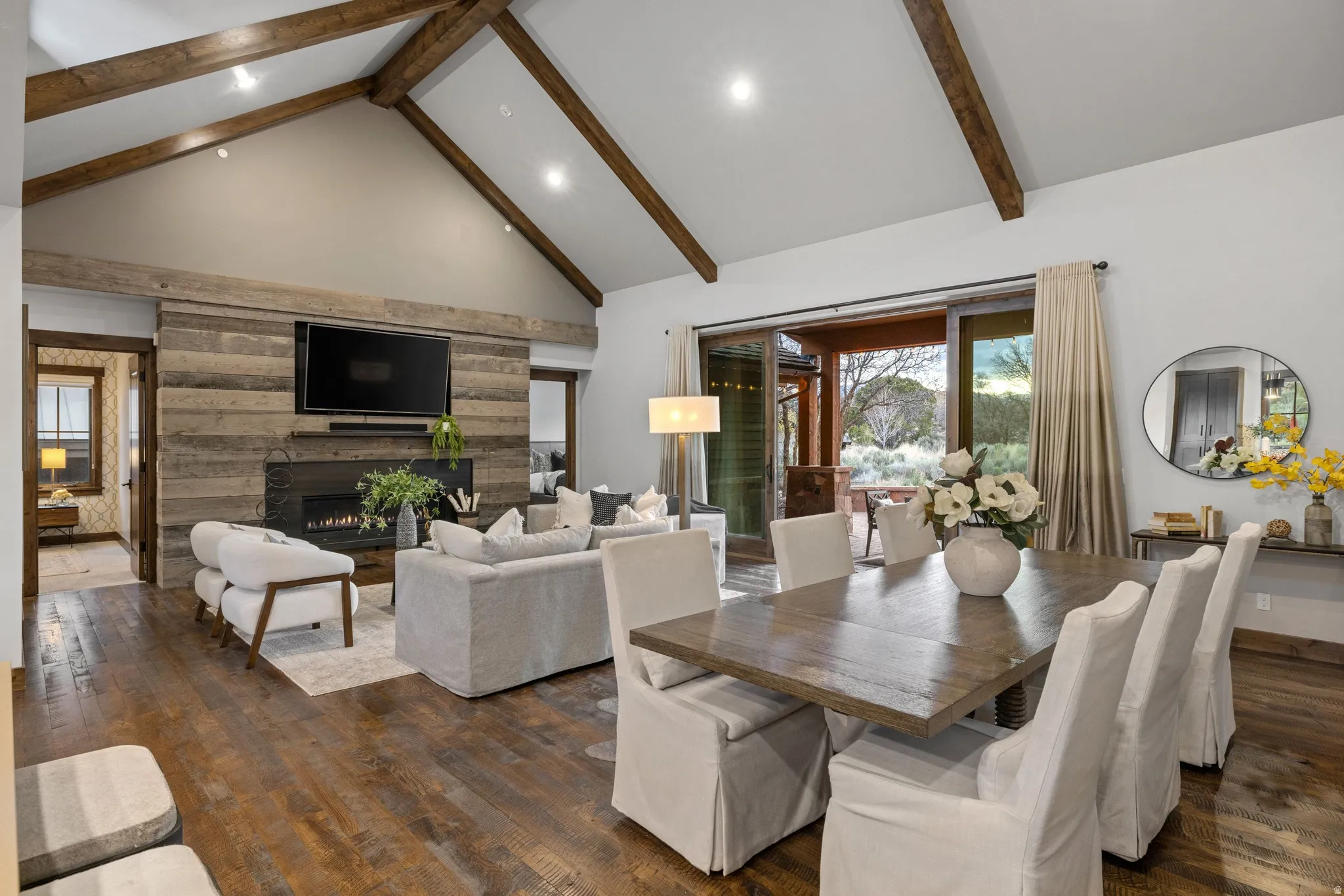 Dining area featuring dark wood-style flooring, a lit fireplace, and recessed lighting