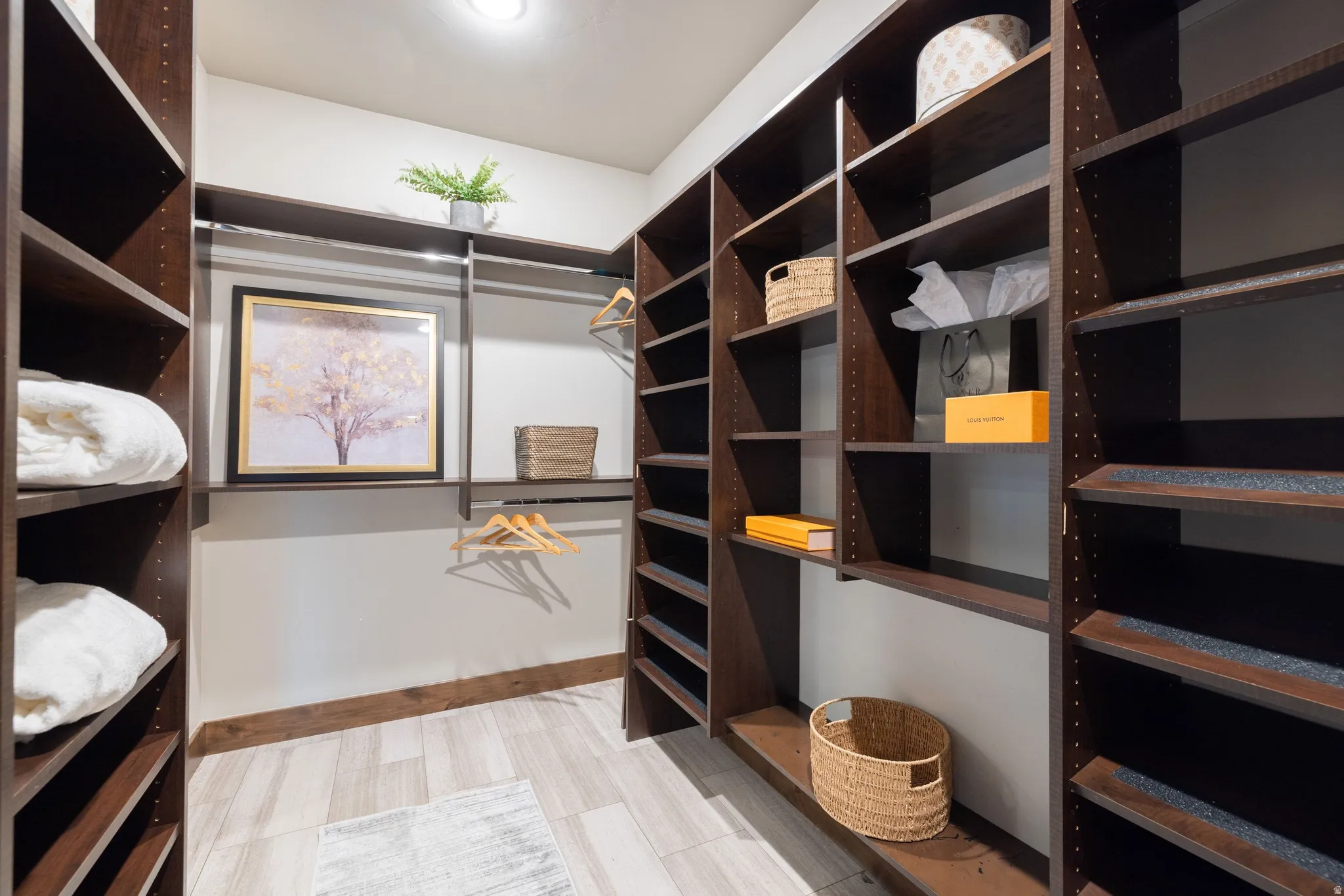 Walk in closet featuring light floors