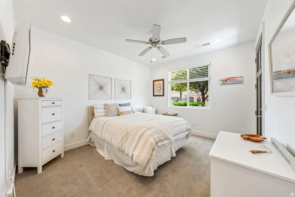 Bedroom featuring light carpet, a ceiling fan, and recessed lighting