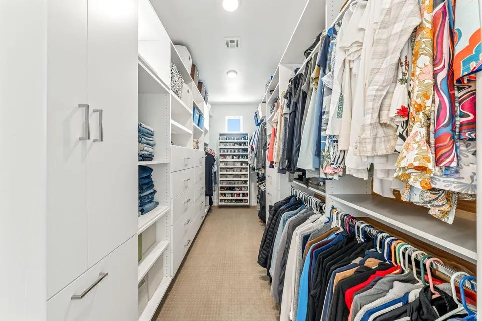 Walk in closet with light carpet
