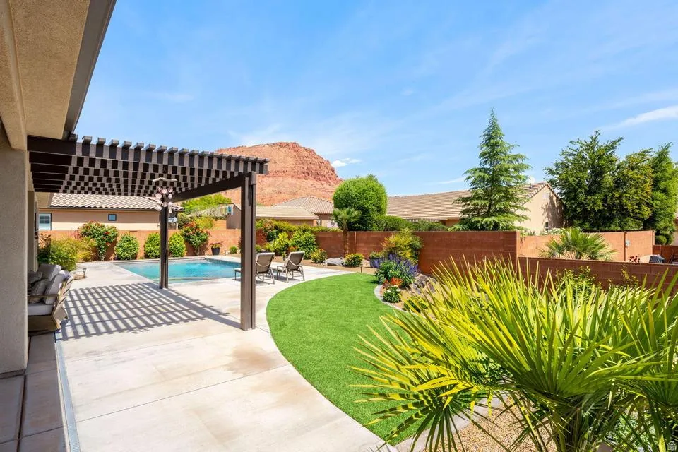 Fenced backyard with a pergola and a patio