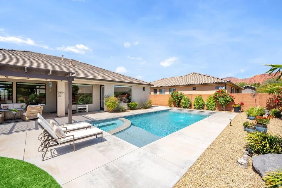 Relaxing pool / spa featuring a patio and a fenced backyard