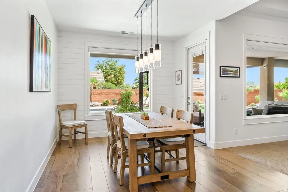 Dining space with wood-type flooring and wooden walls