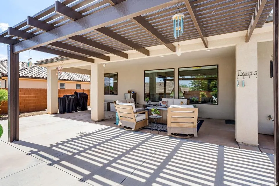 View of patio with a pergola and outdoor seating