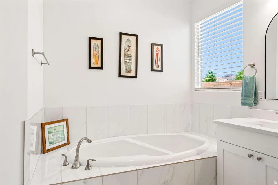 Full bath with a garden tub and vanity