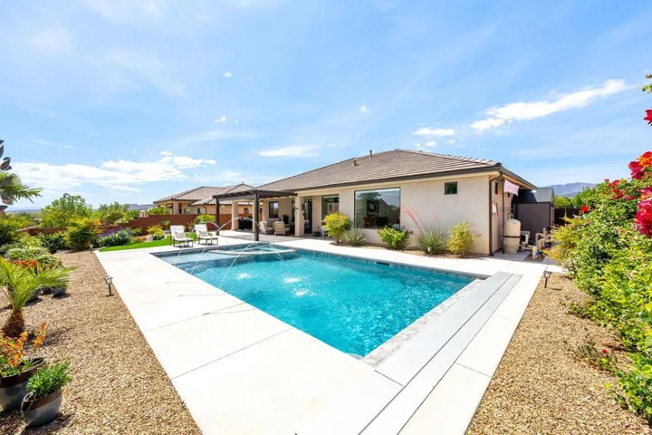 Relaxing pool / spa featuring a fenced backyard and a patio