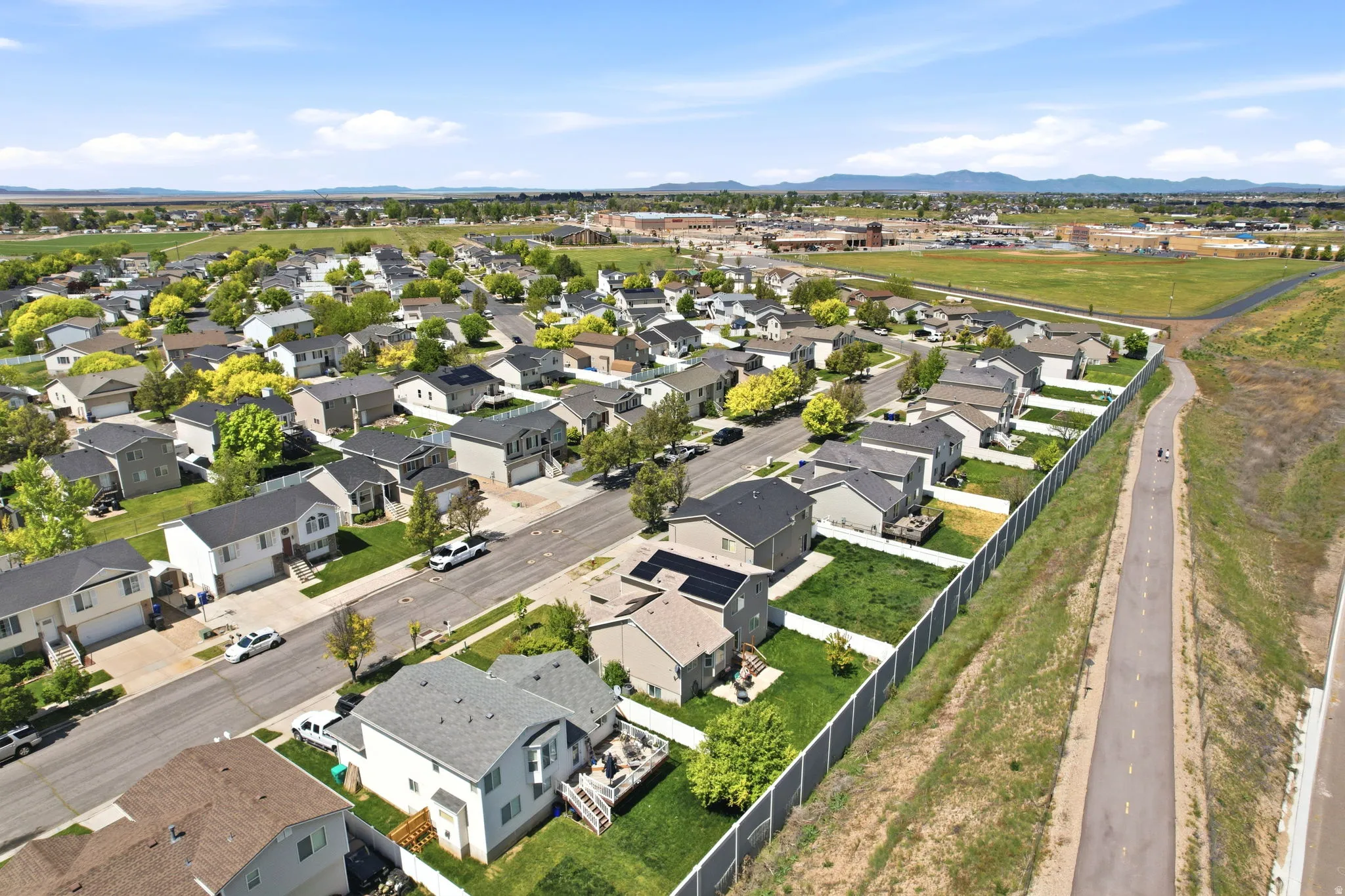 Aerial perspective of suburban area featuring a mountain backdrop