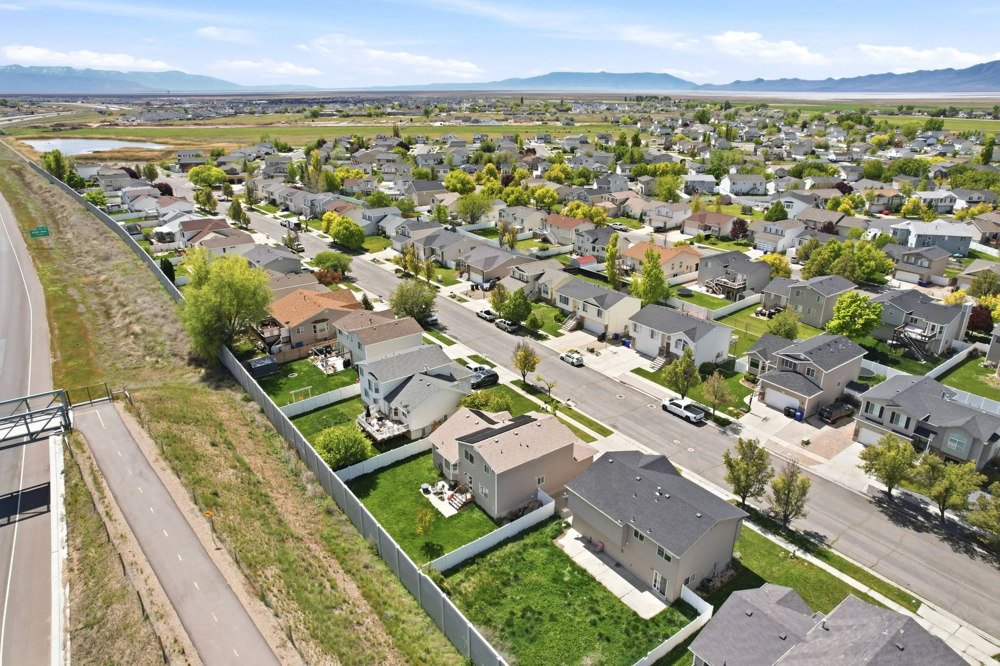 Aerial perspective of suburban area featuring a mountainous background