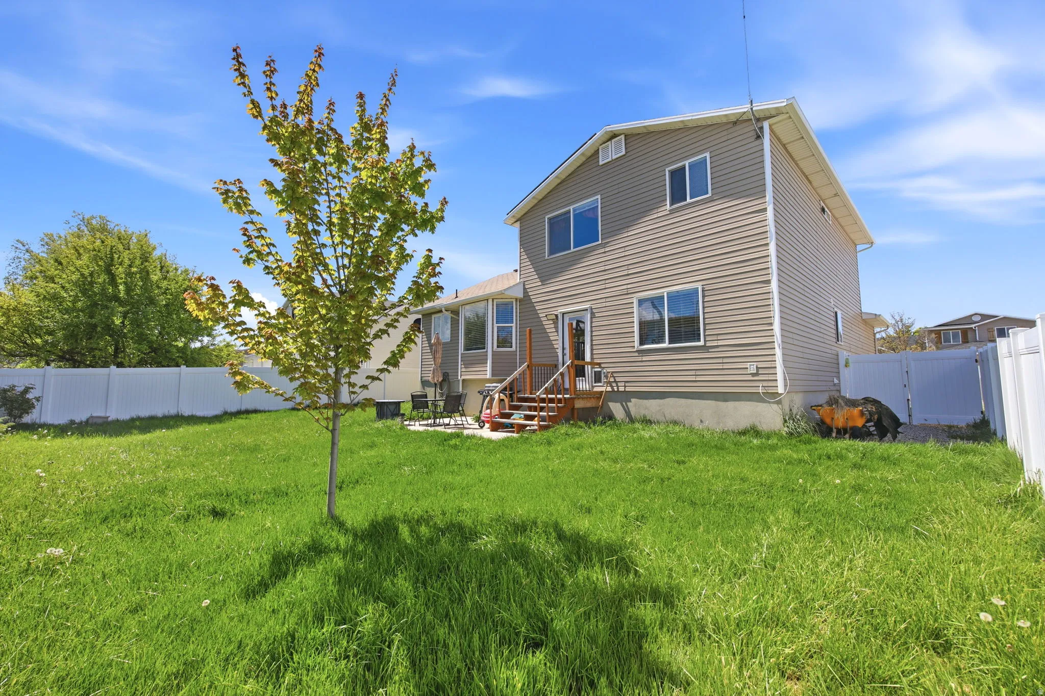 Back of property with a fenced backyard and a gate