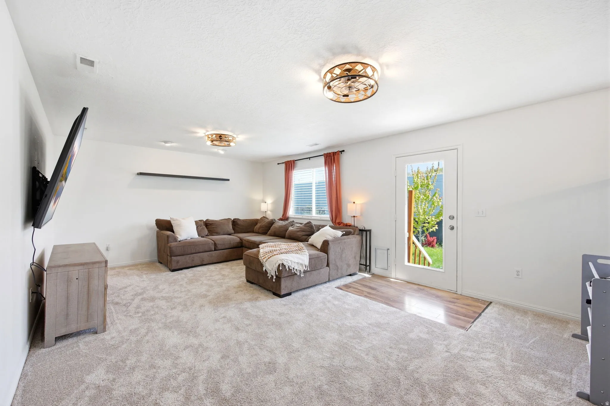 Living area featuring light colored carpet